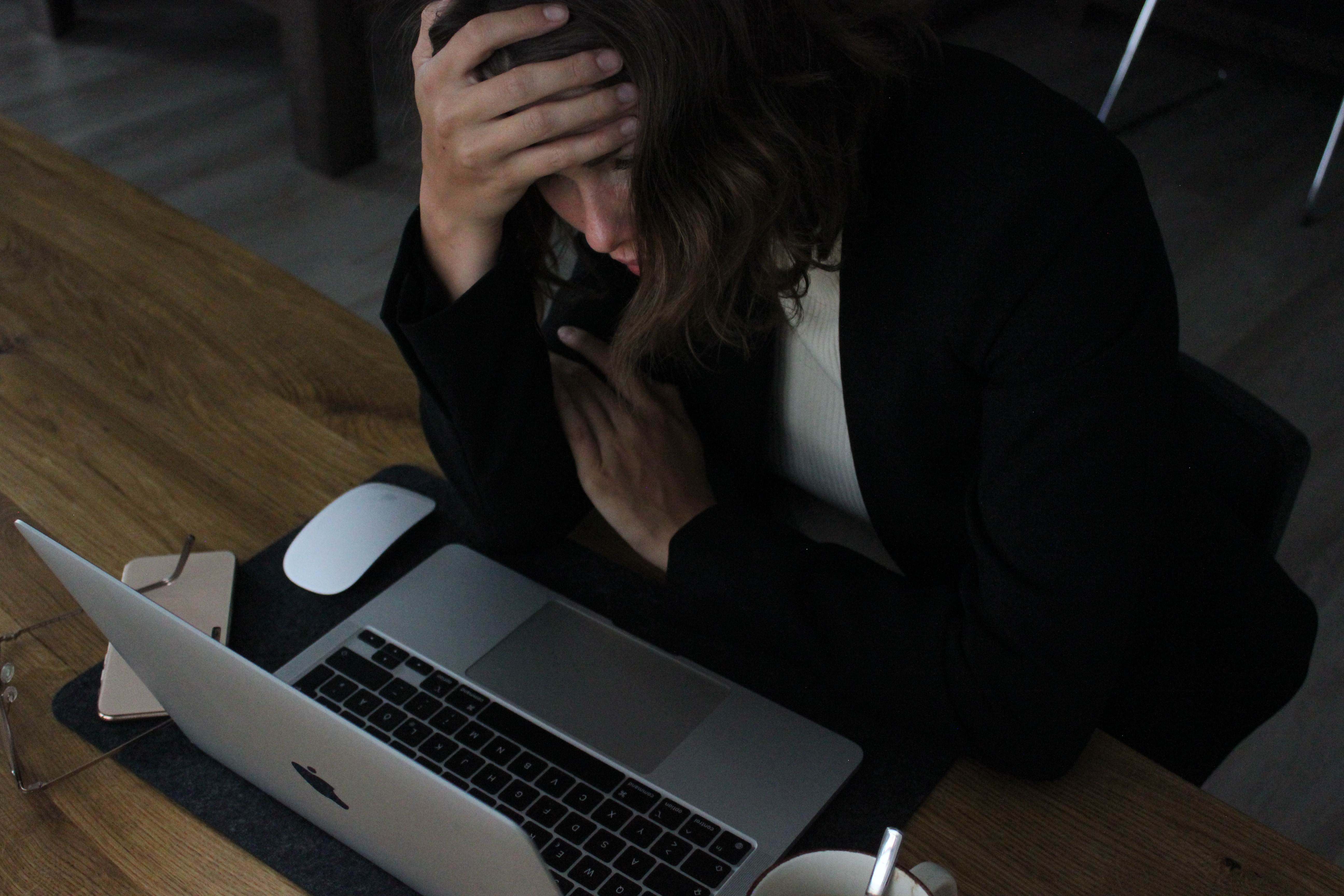 Photo of person looking at laptop in despair